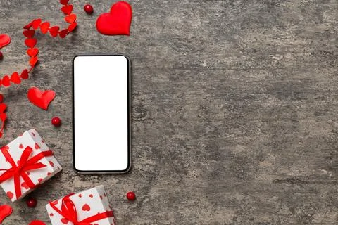 Mobile phone with blank screen on colored background with hearts, valentine d Stock Photos
