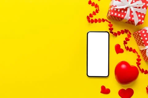 Mobile phone with blank screen on colored background with hearts, valentine d Stock Photos