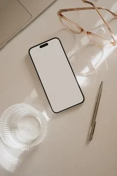 Mobile phone with blank white screen, laptop computer, decanter and glass of  Stock Photos