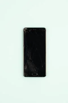 Mobile phone with broken black screen, top view.  Stock Photos