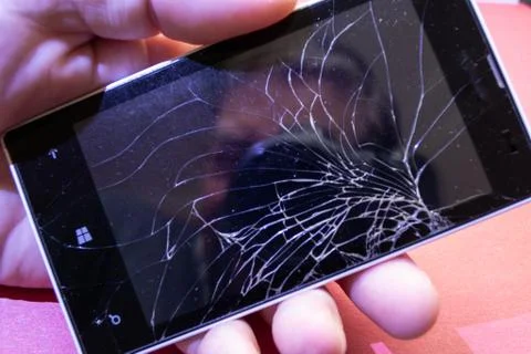 Mobile phone with a broken glass screen. Stock Photos