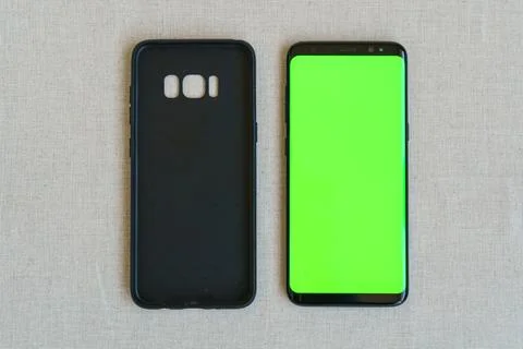 Mobile phone case and mobile phone on table Stock Photos