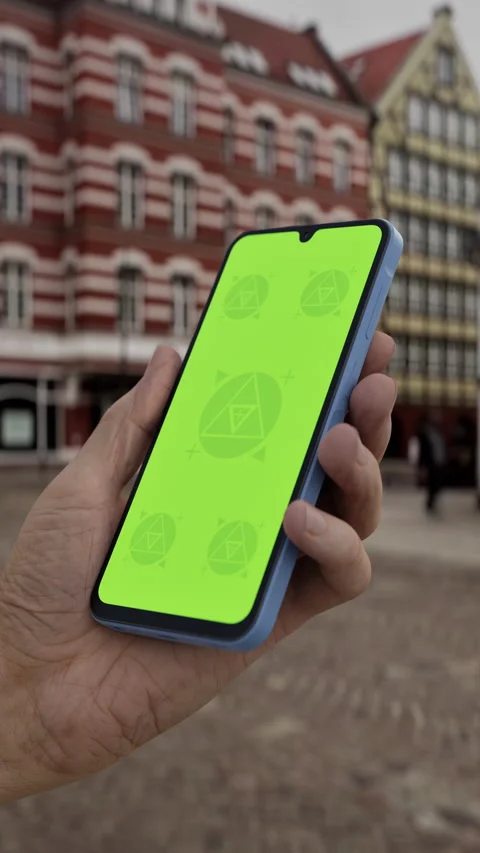 Mobile phone with customizable screen held in hand in a lively urban plaza Stock Footage 293568142