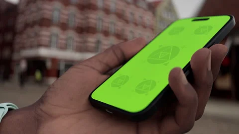 Mobile phone with customizable screen held in hand in a lively urban plaza Stock Footage 294038239