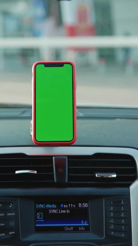 The mobile phone display in a vehicle features a green screen background for Stock Footage 314170412
