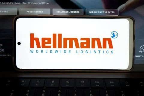 Mobile phone displaying hellmann worldwide logistics brand identity Stock Photos