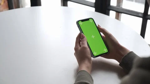 Mobile phone with green screen close up.  Chroma key on   the cell phone. Stock Footage