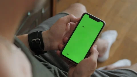 Mobile phone with green screen in hands Stock Footage 312061472