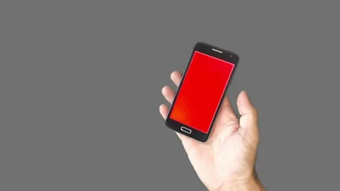 Mobile phone in hand on gray background with glare 스톡 동영상 280362328