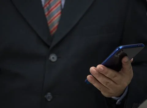 Mobile phone in the hand on the white background with copy space Stock Photos