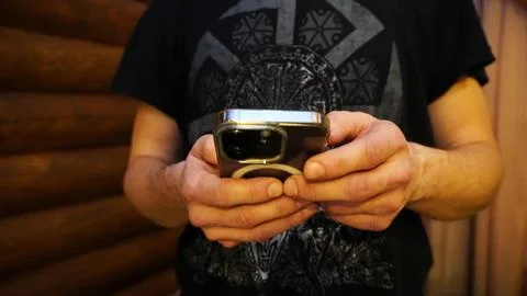 Mobile phone in the hands of a man Stock Photos