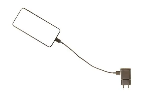 Mobile phone with inserted charger plug isolated on white Stock-Fotos