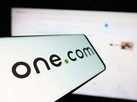 Mobile phone with logo of web hosting company One.com Group in front of bu... Stock Photos