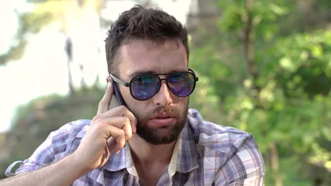 Mobile phone. The man is talking on a cell phone. Stock-Footage 158193476