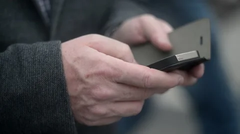 Mobile phone in man's hand chating in the street of Milan - close up Stock Footage 63383451