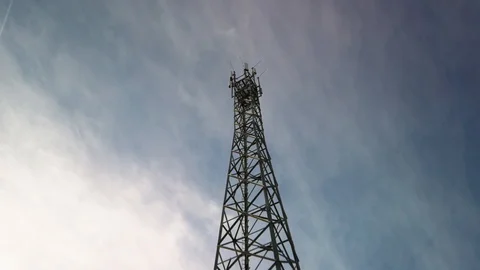 Mobile phone mast with blue sky and airplane Stock Footage