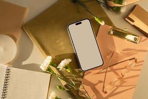 Mobile phone with mockup copy space screen, glasses, laptop, clipboard, carna Stock Photos