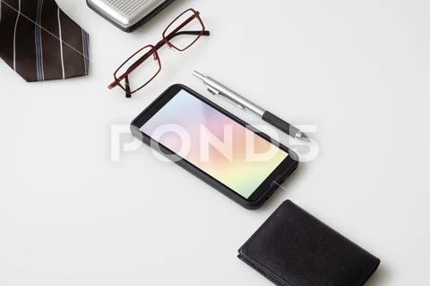 Mobile phone mockup with gentlemen's accessories PSD Template
