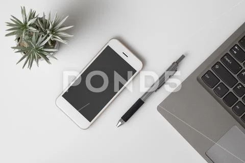 Mobile phone mockup, top view of White office desk table PSD Template