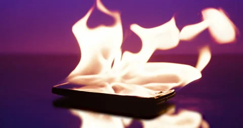Mobile phone overheats and burns. Cell Phone addiction or overuse. Red hot Tech Stock Footage 150680807