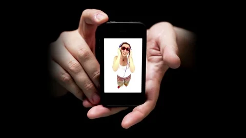 Mobile Phone Screen Shows Young Woman Listening Music and Dancing Stock Footage 70197975
