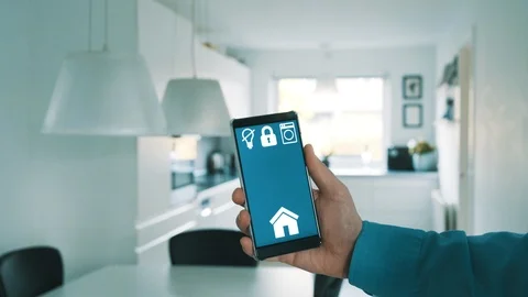 Mobile phone shows app to control light in smart home Stock Footage 101829777