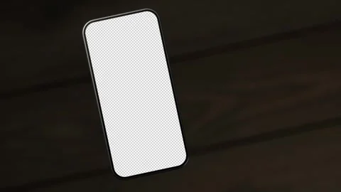 The mobile phone is slightly raised above the wooden table, showing the e-scr Stock-Footage 261365583
