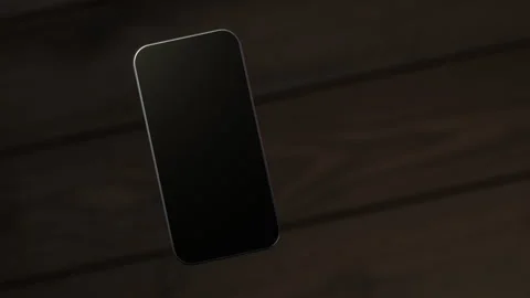 The mobile phone is slightly raised above the wooden table, showing the scree Video stock 261365745