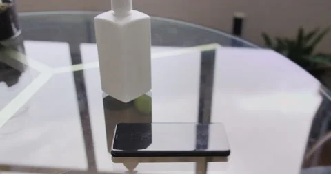 Mobile phone on the table and alcohol sanitizer bottle. Healthcare, protect and Stock-Footage 132013743