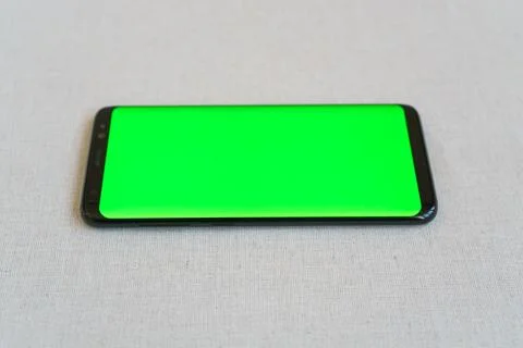 Mobile phone on table horizontally with blank screen Stock Photos