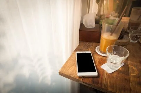 Mobile phone on table Stock Photos