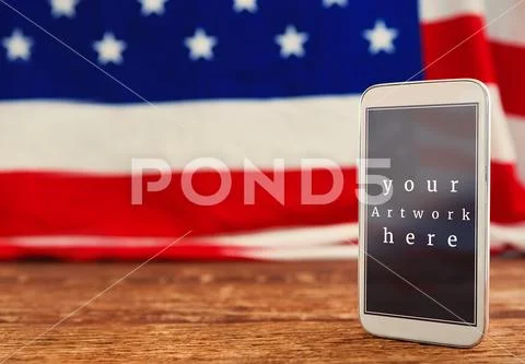 Mobile phone template on wooden table PSD Template