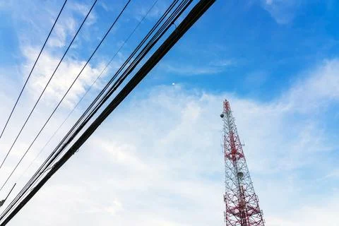 Mobile phone tower, base station or monopole with the moon in clear blue sk.. 写真素材