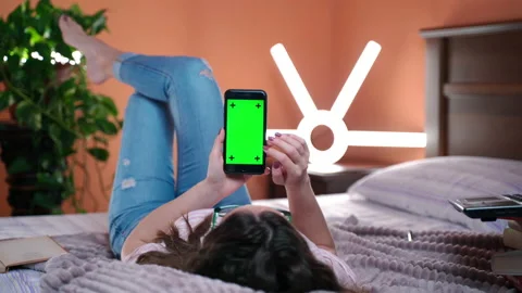 Mobile phone with vertical green screen mock-up, social network browsing Stock Footage 133428331