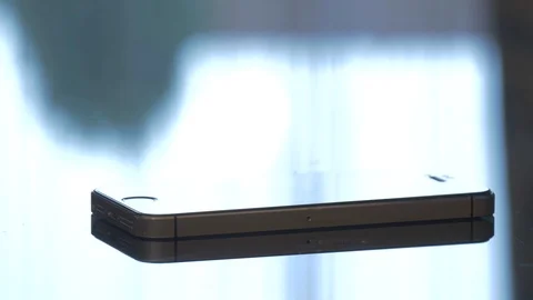 Mobile phone on vibrating on a table Stock Footage 87364421