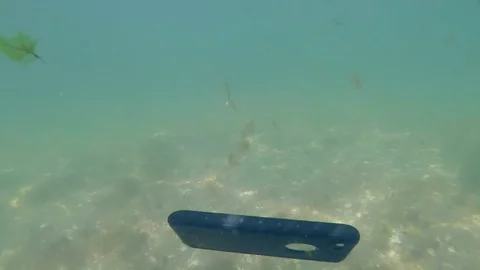 Mobile Phone in Waterproof Case Drop into the Sea Water. HD, 1920x1080 Slow Stock Footage 78436335