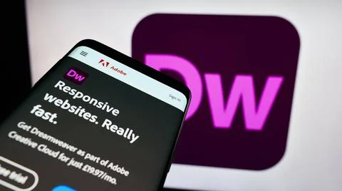  Mobile phone with website of web development software Adobe Dreamweaver o... Stock Photos