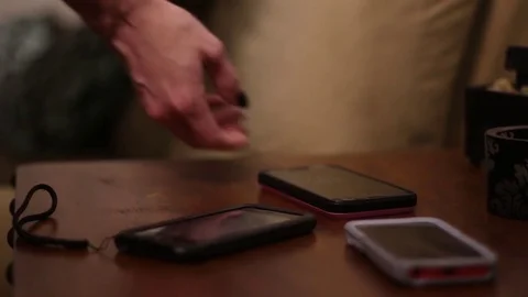 Mobile Phones Set on End Table Stock Footage 77010113