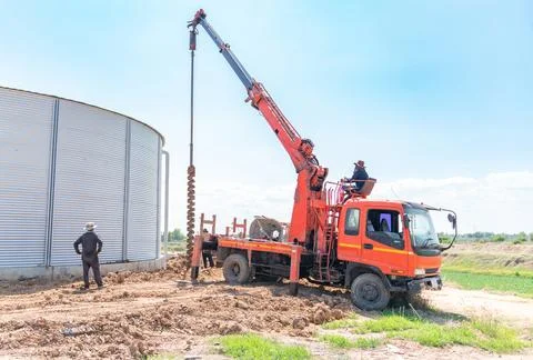 Mobile pile driver drill pit for pole foundation support silo tank. Stock Photos