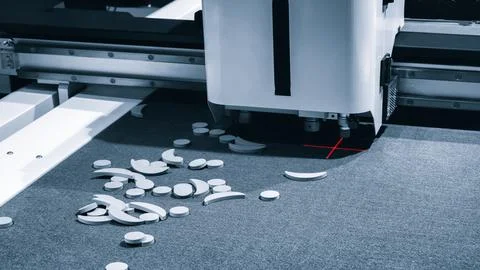Mobile robotic unit emits red laser beam. Small white circular objects lie sc Stock Photos