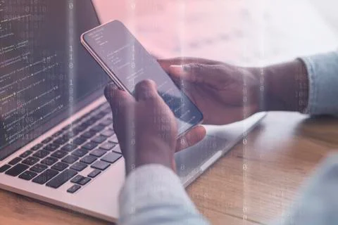 Mobile Security Concept. Black man using phone and laptop Stock Photos