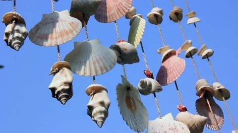 Mobile Shell hanging on the sky background and glowing sunlight. HD. 1920x1080 Stock Footage 67251188