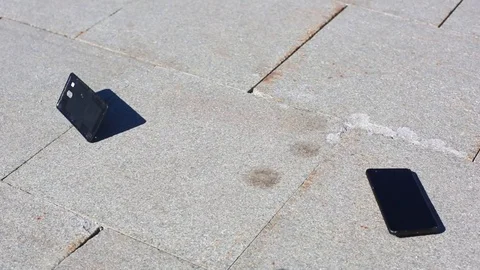Mobile smart phone falling and breaking. Hand picking up telephone from ground Stock Footage 106707239