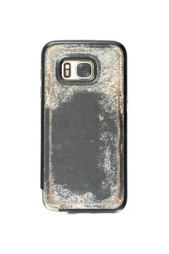 Mobile smartphone with camera in a used Old and dirty plastic case. Backside  Stock Photos