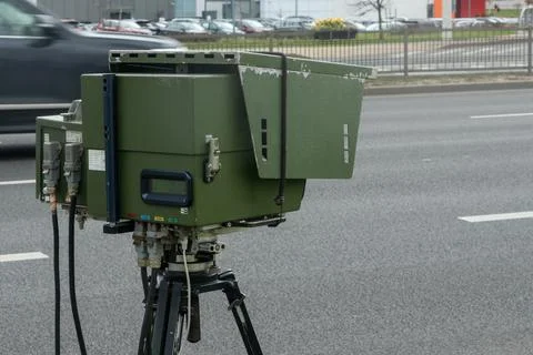 Mobile speed camera on a tripod at the roadside. Professional law enforceme.. Photos