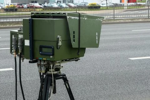 Mobile speed camera on a tripod at the roadside. Professional law enforceme.. Photos
