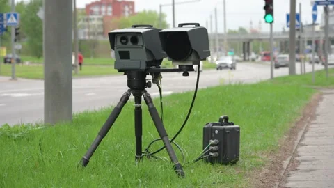 Mobile speed trap camera resembling a VITRONIC Poliscan FM1 set on a roadside Stock Footage 336587739