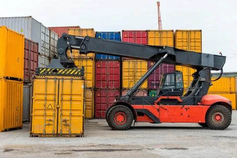 Mobile stacker handler in action at a container terminal. Stock Photos
