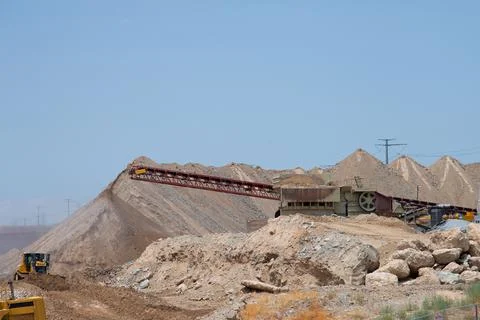 Mobile stone crusher machine by the construction site or mining quarry for cr Stock Photos