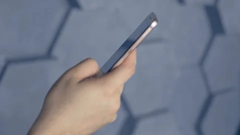 Mobile technology and digital device addiction. smiling man holding phone. Stock Footage 105322166